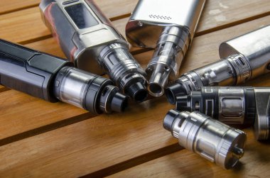 Popüler vaping e cig aygıtları mod.electronic sigara ahşap arka plan üzerinde. Buharlaştırıcı e-cig eski aygıt modeli. 