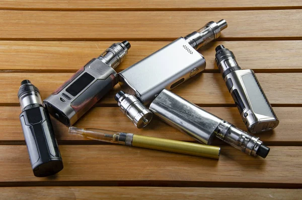 Populära Vaping Cig Enheter Mod Electronic Cigarett Över Trä Bakgrund — Stockfoto