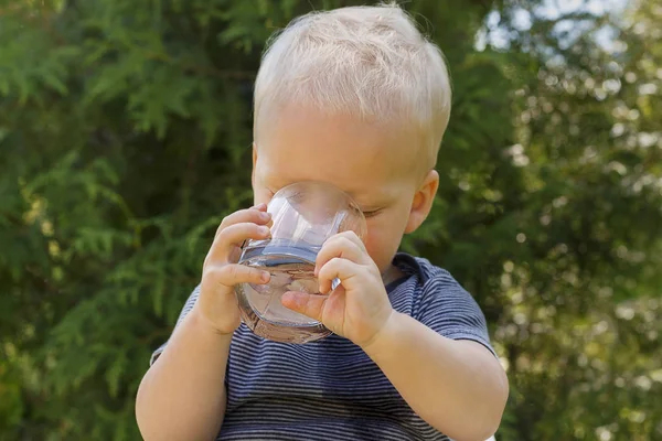 Портрет милий малюк питної води зі скла на відкритому повітрі — стокове фото
