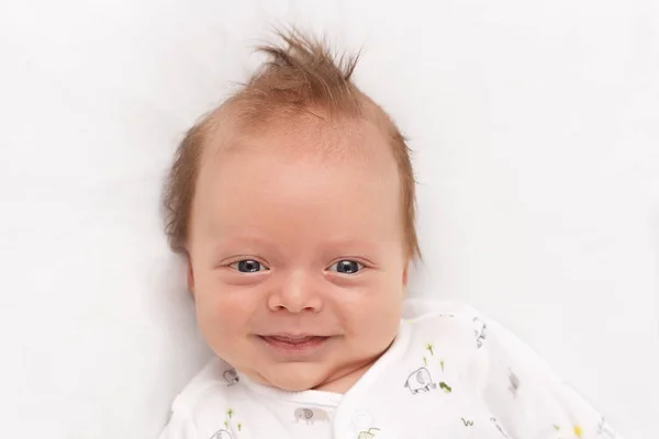 Söt leende nyfödda pojke. Bedårande spädbarn tittar på kameran. Kopiera utrymme — Stockfoto