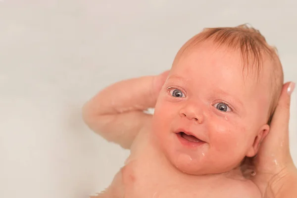 Cara cercana de linda y saludable sonrisa de niño bebé durante la hora del baño . —  Fotos de Stock