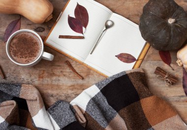 Kırsal ahşap arka plan ile kabak ve sonbahar yaprakları, bir fincan kahve ya da kakao, bir dizüstü bilgisayar, bir ekose bir kafes ile Sütlü Balkabağı. Sonbahar arka plan.