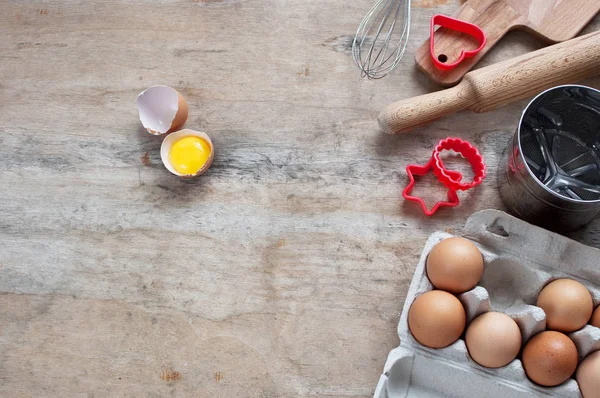 Kitchen items Metal Utensils Spoon Eggs on a wooden table. Cooking Baking Eggs Groceries Top View kitchenware