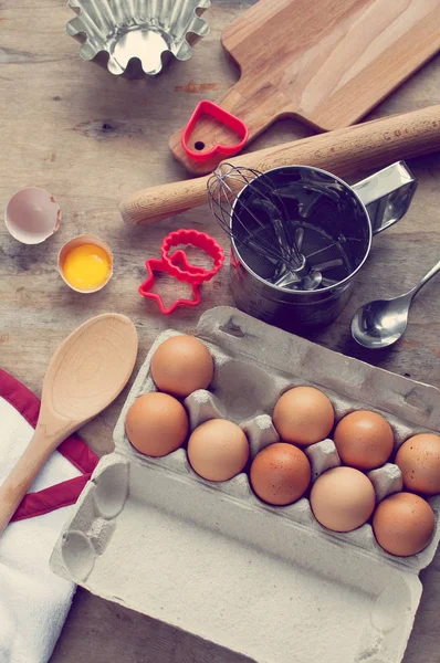 Kitchen items Metal Utensils Spoon Eggs on a wooden table. Cooking Baking Eggs Groceries Top View kitchenware tinted photo