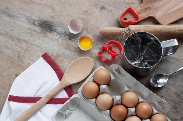 Kitchen items Metal Utensils Spoon Eggs on a wooden table. Cooking Baking Eggs Groceries Top View kitchenware
