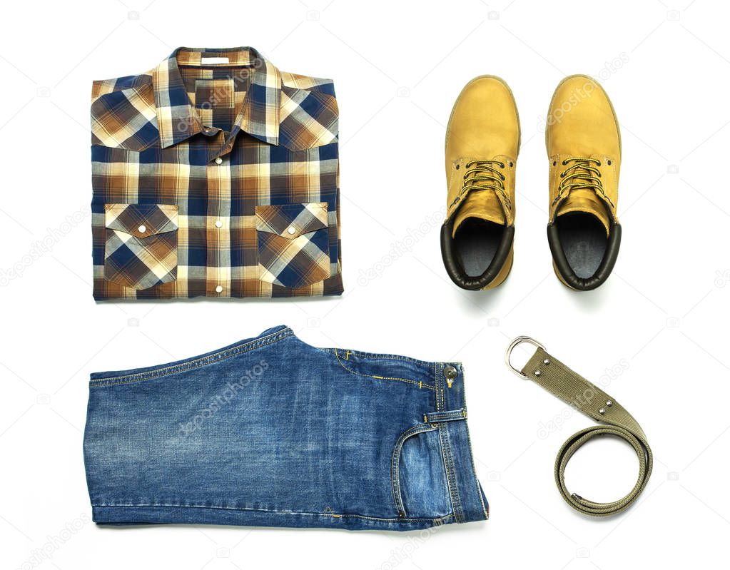 Flat lay set Men's casual clothing, blue jeans, checkered shirt, yellow nubuck shoes, strap isolated items on white background top view with space for text. Male fashion, clothes for rest, travel