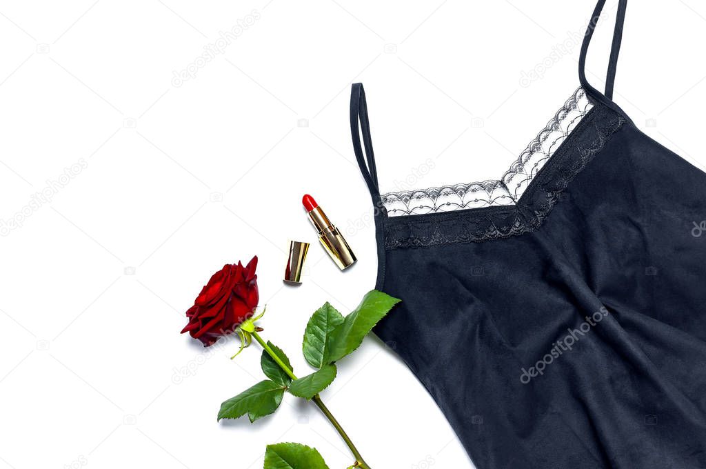 Female black T-shirt jacket with lace, red lipstick and rose flowers on white background top view flat lay. Beauty fashion background. Sexy clothes, fashion look, women's holiday