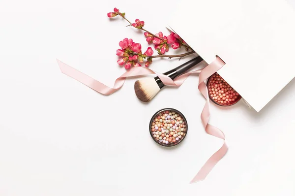 Ball blush rouge and face powder, makeup brush, spring pink flowers in white gift package on light background top view flat lay. Different makeup cosmetic. Beauty fashion background shopping concept — Stock Photo, Image