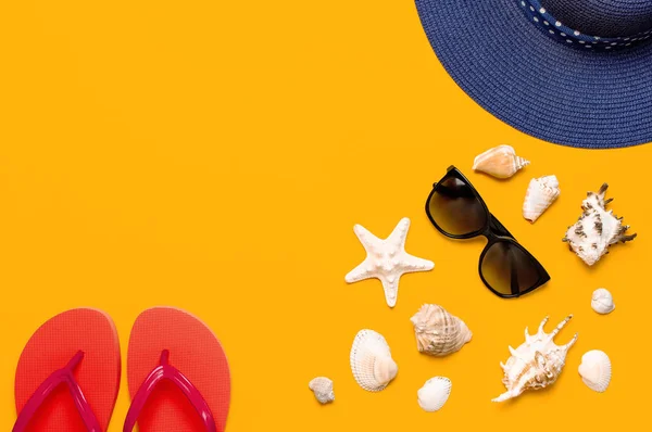 Summer beach sea accessories. Coral flip flops, blue straw hat, sunglasses, shells, starfish on yellow background top view flat lay copy space. Summer background. Holiday vacation travel concept. — Stock Photo, Image