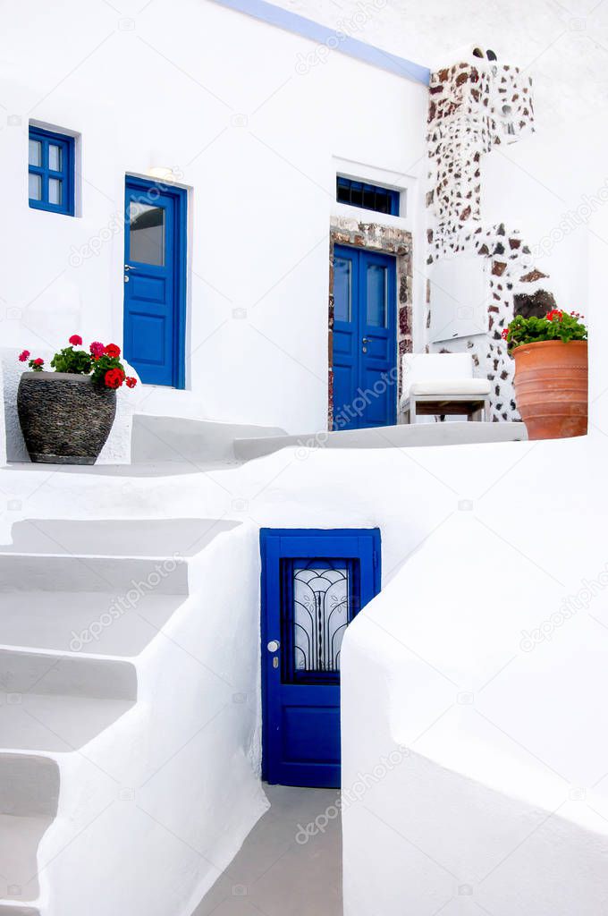 Classic white Greek architecture with blue doors and shutters, Santorini, Greece, Aegean sea, Europe. Travel concept, details of the one of the most beautiful travel destinations of the world