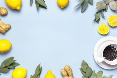 Creative food concept. Fresh ginger root, cup tea with brewing inside, lemon, eucalyptus leaves on blue background. Flat lay top view copy space. Minimalistic style seasoning spice ingredient for tea clipart