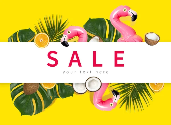 Creative concept of summer sales. Inflatable pink mini flamingo tropical palm leaf monstera coconut orange on yellow background pool float party. Flat lay Flamingo Trend Inflatable Toy Discounts sale
