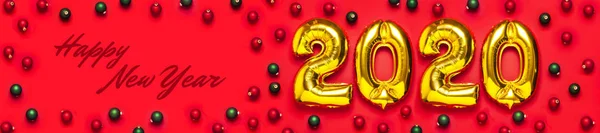 2020 opblaasbare gouden nummers met rode en groene kerstballen op rode achtergrond. Nieuwjaar winter decoratie, vakantie symbool, partij item. Merry Christmas wenskaart. Gelukkig Nieuwjaar. Platte lay — Stockfoto