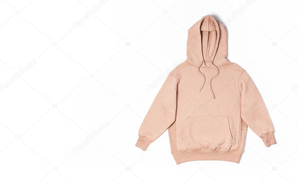 Female peach pink sweatshirt with pocket and hood isolated on white background. Fashionable women's clothing, hoody, casual youth style, sports. Autumn fashion