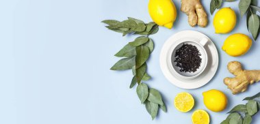 Creative food concept. Fresh ginger root, cup tea with brewing inside, lemon, eucalyptus leaves on blue background. Flat lay top view copy space. Minimalistic style seasoning spice ingredient for tea clipart