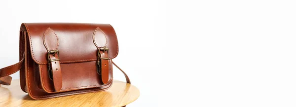 Fashionable Brown Women Bag Made Genuine Leather Wooden Table White — стоковое фото