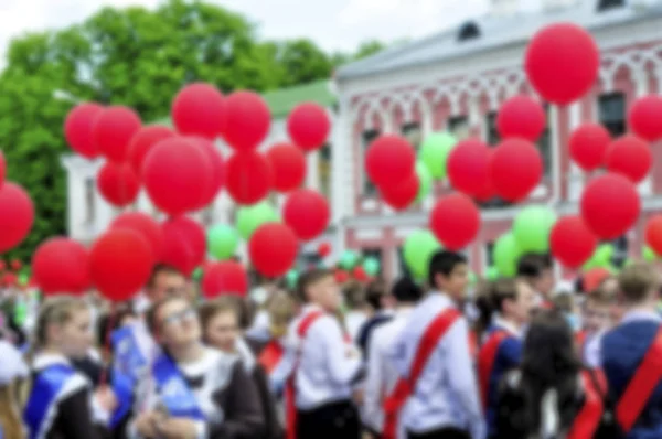 Blurred Background. The last call at school. Parade of schoolchildren, graduates with bright balloons colorful in hands.