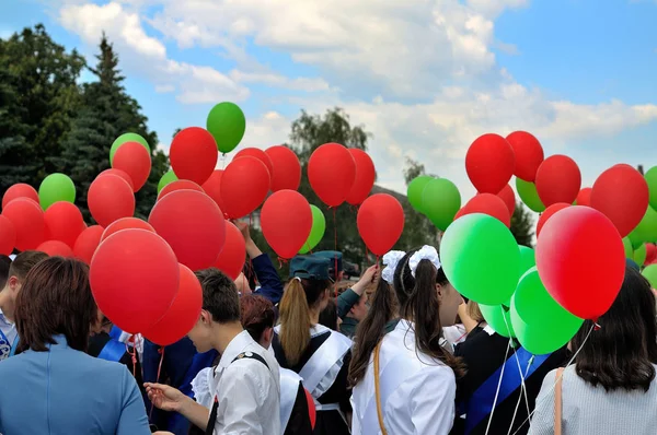 The last call at school. Parade of schoolchildren, graduates with bright balloons colorful in hands.