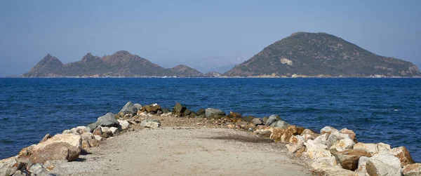 Rocks on shore of Aegean sea. Place for recreation, picnic.  Beach resort area of Turkey. Turgutreis , Bodrum.