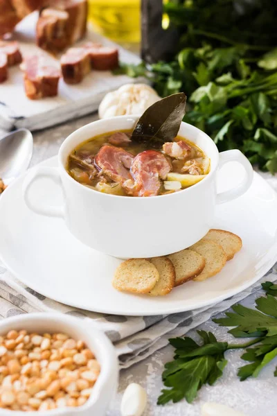 Traditional homemade thick pea soup with smoked meat in a white plate for a family dinner — Stock Image Traditional Homemade Thick Pea Soup Smoked Meat White Plate Family Stock Photo