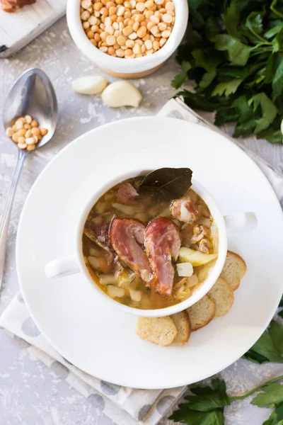Traditional homemade thick pea soup with smoked meat in a white plate for a family dinner — Stock Image Traditional Homemade Thick Pea Soup Smoked Meat White Plate Family Stock Photo