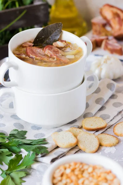 Traditional homemade thick pea soup with smoked meat in a white plate for a family dinner — Stock Image Traditional Homemade Thick Pea Soup Smoked Meat White Plate Family Royalty Free Stock Images
