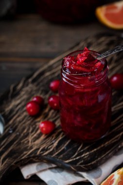 Baharatlı kızılcık-portakal sosu koyu ahşap arka plan üzerinde et için