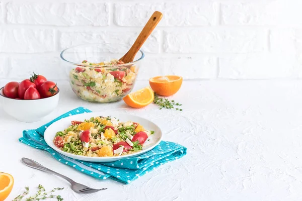 Healthy and simple food, light summer lunch, fragrant salad with couscous and oranges