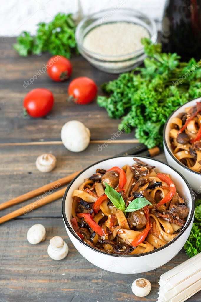 Wheat noodles udon with mushrooms and vegetables in Tereyaki sauce