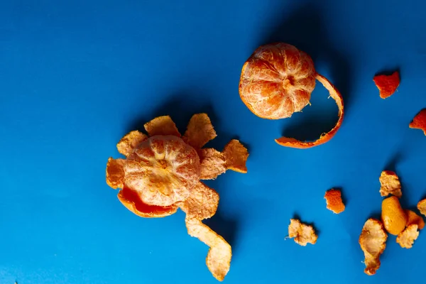 Still life of oranges and tangerines on blue background for advertising photography