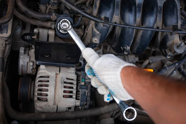 mechanic men with wrench repairing car engine at