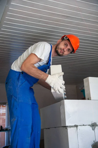 Mason aligning aerated autoclaved concrete block of constructed house wall — Stock Image Mason aligning aerated autoclaved concrete block of constructed house wall Royalty Free Stock Images