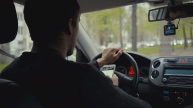 harita app onun akıllı bir araba kullanan genç adam. Görüntüleri genç adam tekerlek behind