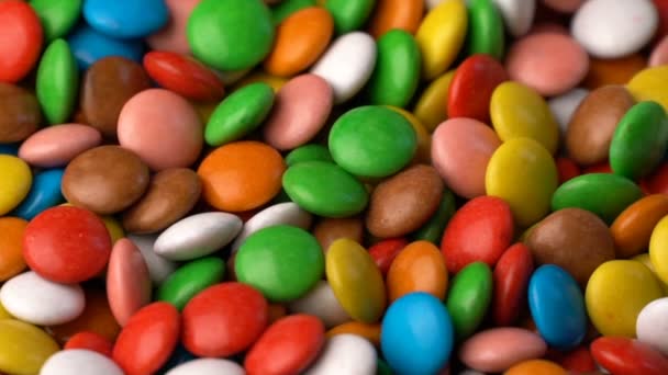 bonbons au chocolat colorés tournent fond. Vidéo au ralenti 