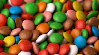 Renkli çikolata şeker döndürmek arka plan.
