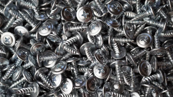 Many self tapping screws background — Stock Photo, Image