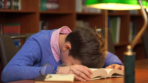 Portrait of schoolboy doing their homework and sleeping on the book. — Stock Photo, Image