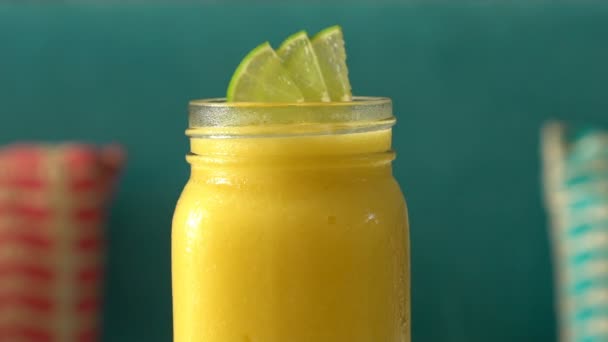 Fresh tropical organic mango smoothie rotate on table. — Stock Video