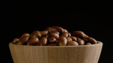 Siyah arka plan üzerinde meşe palamutlarının yakın çekim rotasyonu