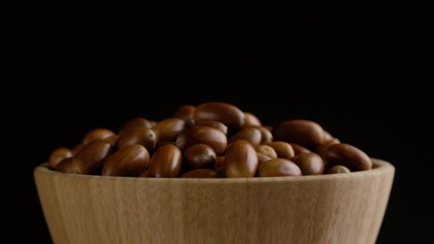 Close-up rotation of oak acorns on black background — Stock Video