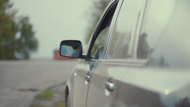 Driver throwing away plastic bottle from car window on road. — Stock Video