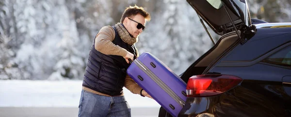 Handsome Man Going Vacations Loading His Suitcase Car Trunk Winter — Stock Photo, Image