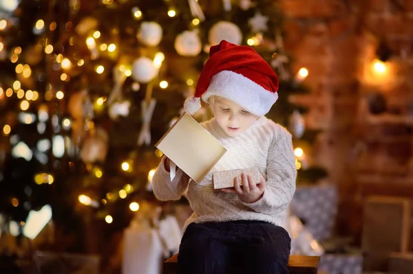 Cute Little Boy Wearing Santa Hat Opening Christmas Gift Portrait — Stock Photo, Image