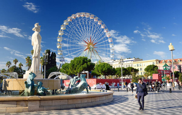 NICE, FRANCE - DECEMBER 14 2018: View of Fountain and Ferris wheel on Massena square. Travel and tourism.