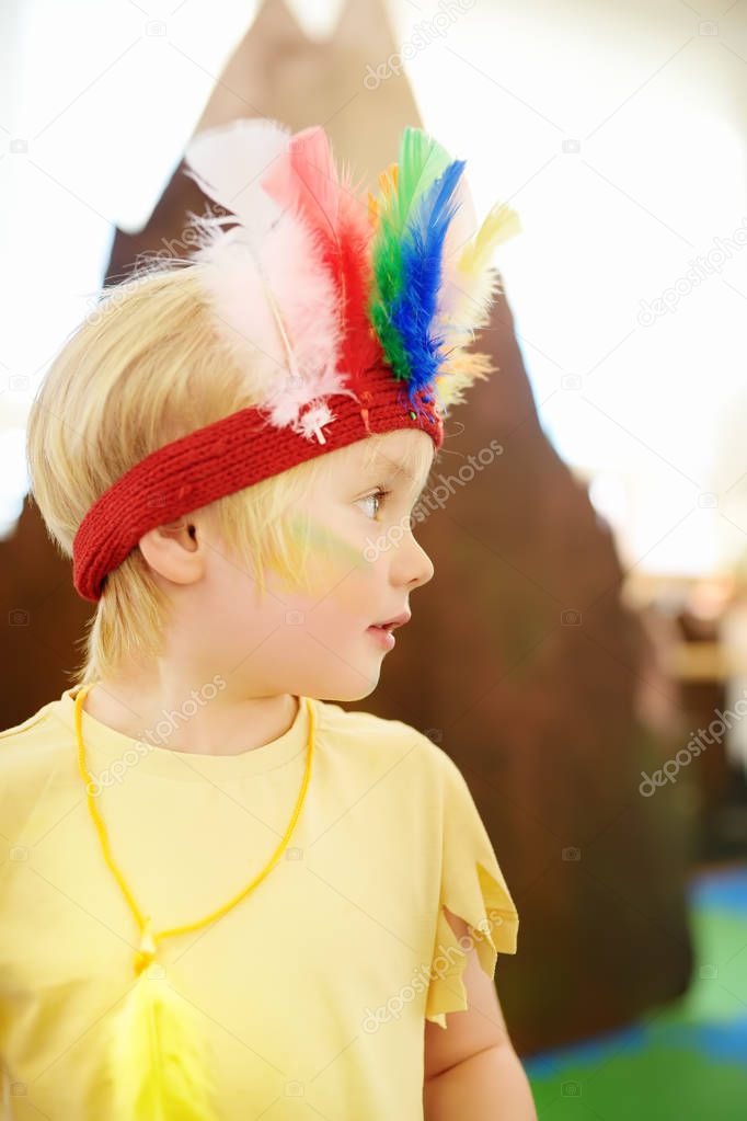 Little boy involved in performance children's theatre Studio in the role of the American Indian. Child perform kids playing Injuns on stage in theater.