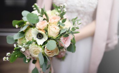 Gelin holding şık düğün çiçekleri. Elegance rustik tarzı pastel renkler buket kadın elinde