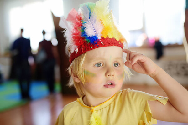 Little boy involved in performance children's theatre Studio in the role of the American Indian.