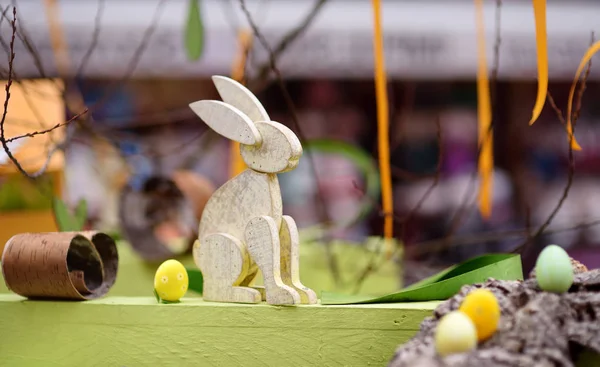 Easter decorations on the street of small town in France. Easter painted eggs and wooden bunny toys as decoration. — Stock Photo, Image