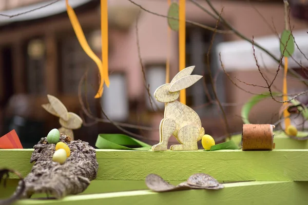 Easter decorations on the street of small town in France. Easter painted eggs and wooden bunny toys. — Stock Photo, Image