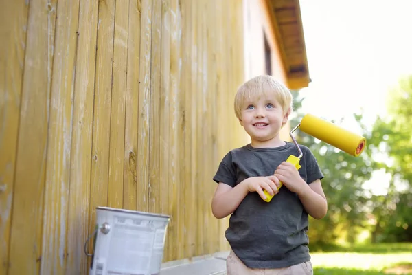 Little boy preparing to paint the wall of the house. Repair. — Stock Photo, Image